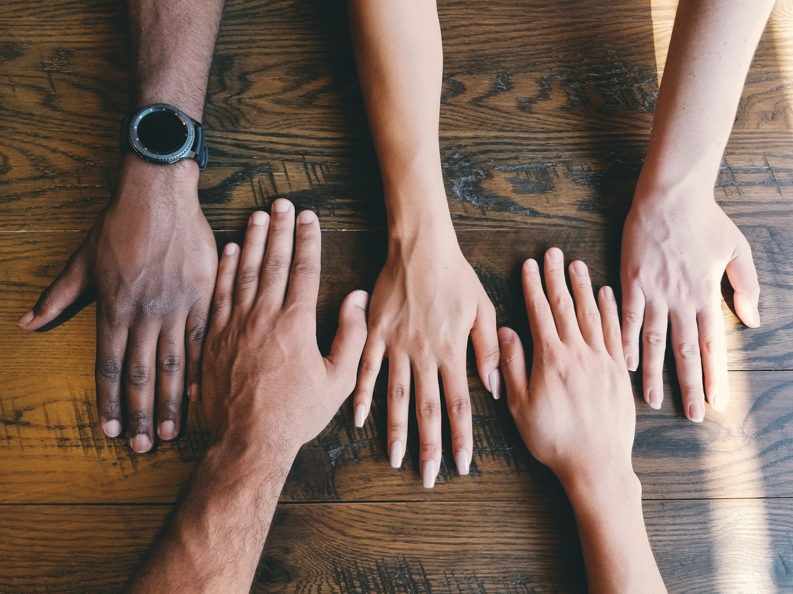 Hands meeting in a circle of community